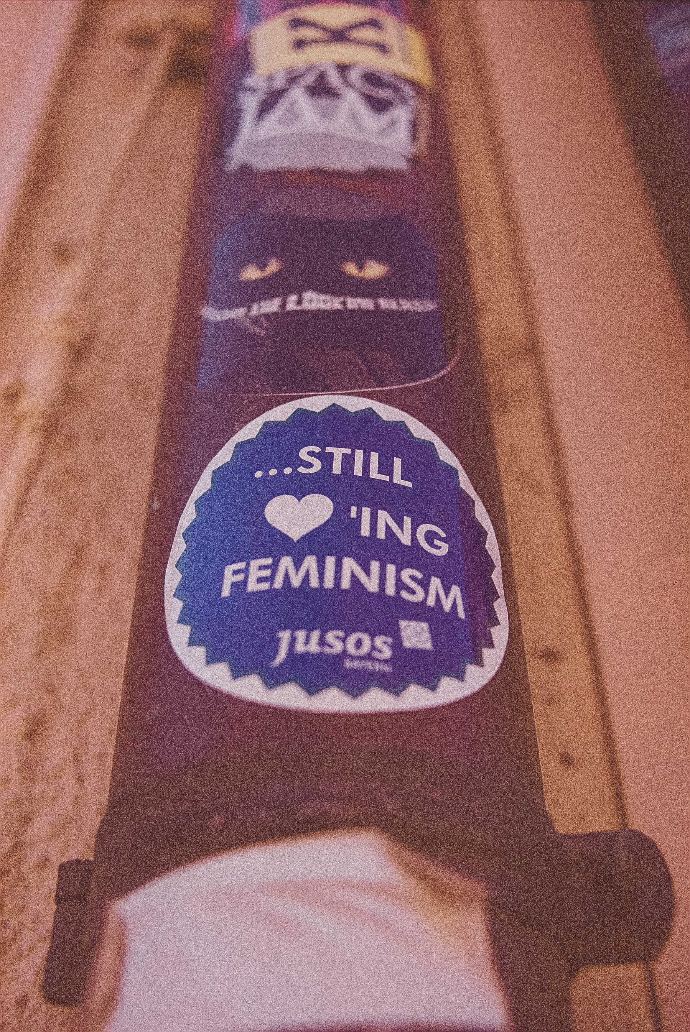 A image with an object that has Still Loving Feminism written on it